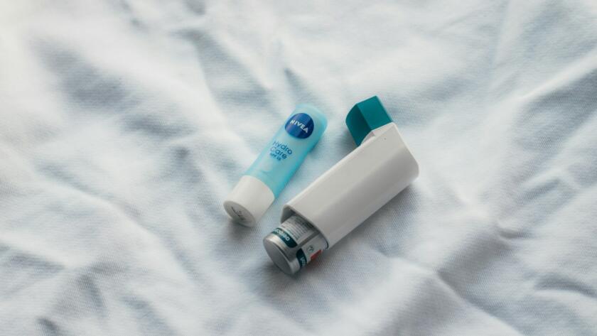 two toothbrushes sitting on top of a white sheet