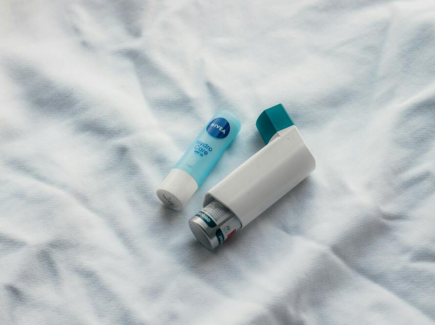 two toothbrushes sitting on top of a white sheet